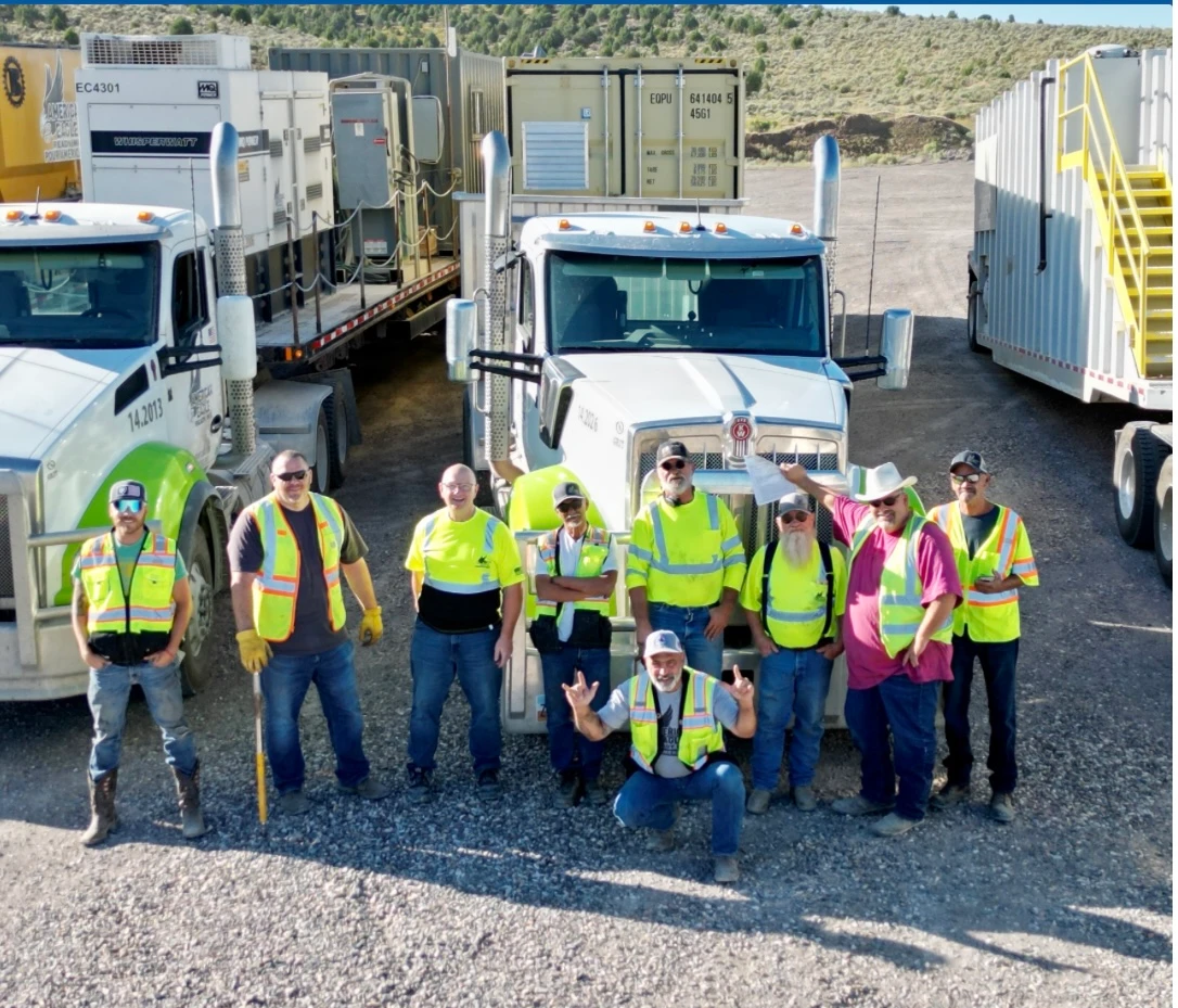 team photo in front of trucks